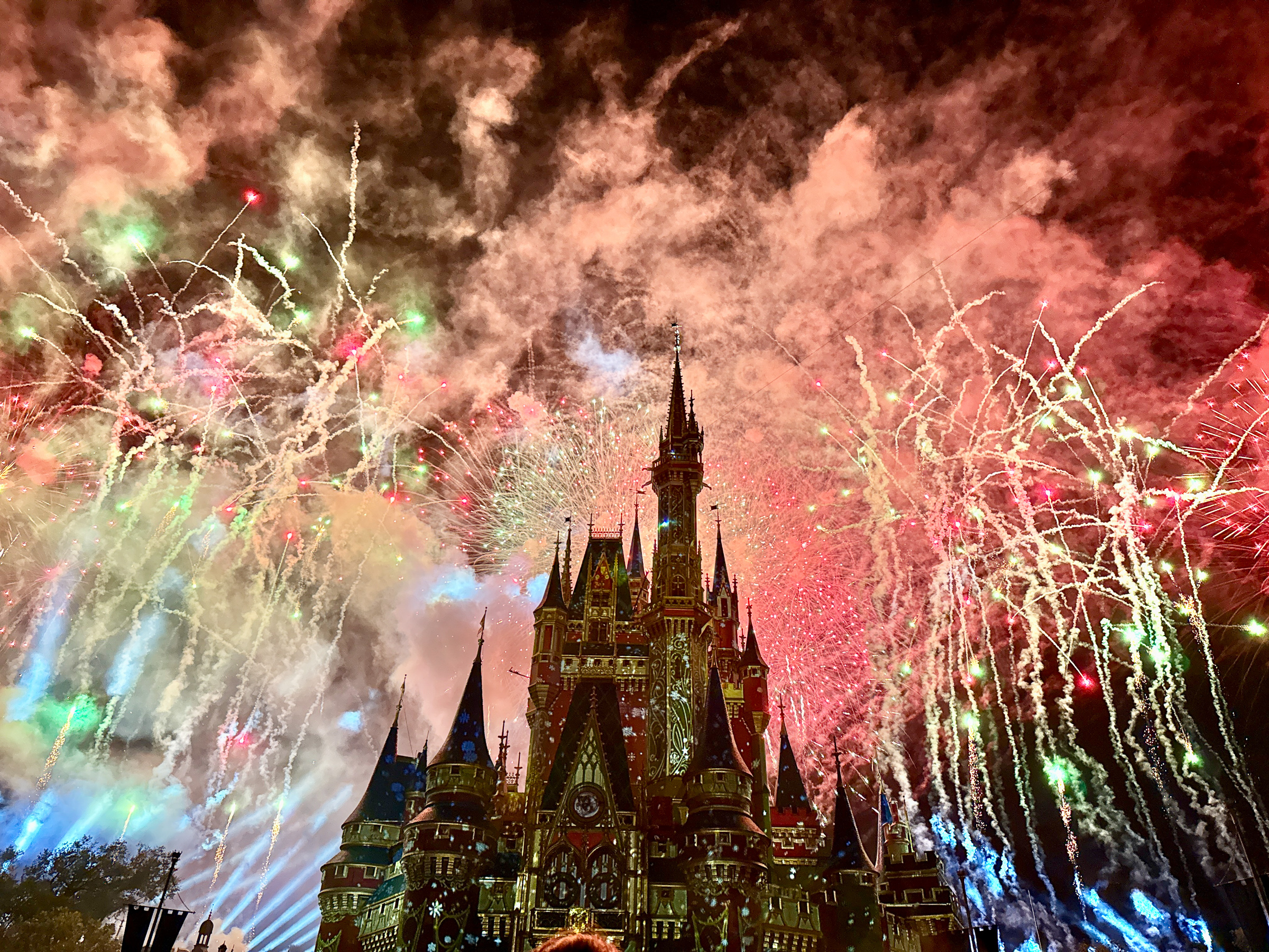 Christmas fireworks filling the sky above Cinderella Castle at Magic Kingdom.
